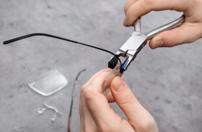 closeup-optician-fixing-glasses-frame-with-special-pliers_403156-186