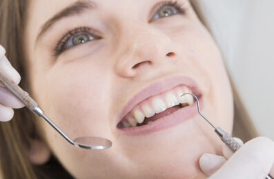 woman-having-teeth-examined-at-dentists_23-2147879263